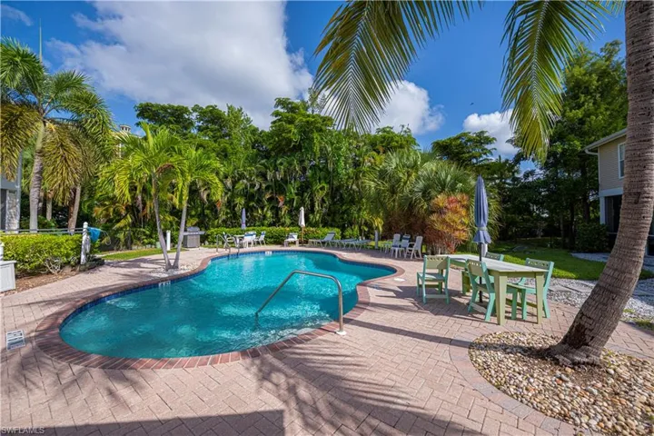 Community pool with a patio