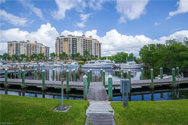 Dock featuring a water view and a lawn