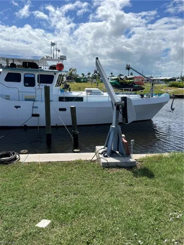 Dock area featuring a water view and a yard