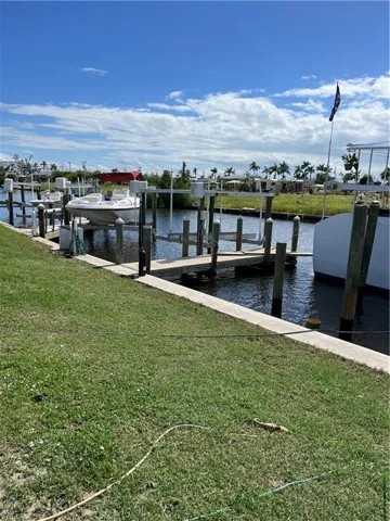 View of dock featuring a water view and a yard