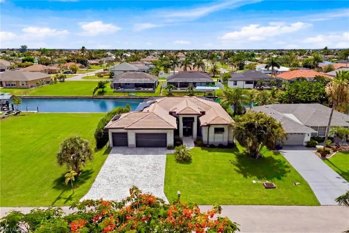 Waterfront property featuring a tile roof and an attached two-car garage