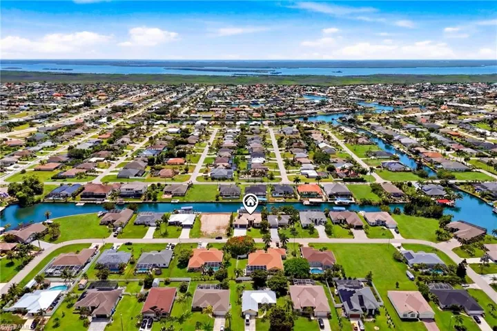 Expansive aerial perspective showcasing a residential community with abundant waterways