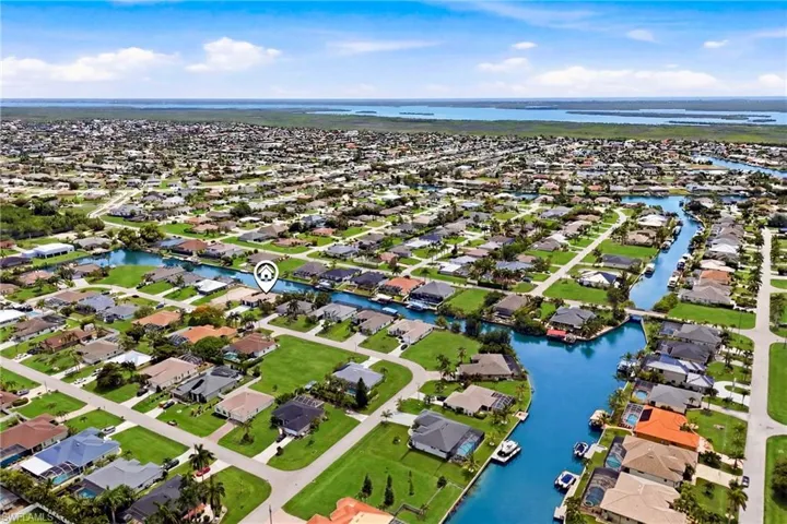 Aerial perspective showcasing a residential community with numerous canals and private docks