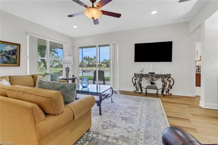 Living room featuring ceiling fan and hardwood / wood-style floors