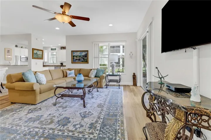 Living room featuring ceiling fan and light wood-type flooring