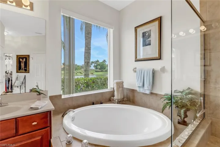 Bathroom featuring a washtub and vanity