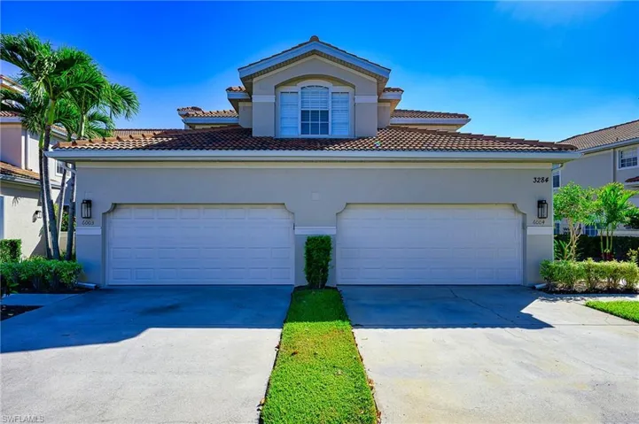 Mediterranean / spanish home featuring stucco siding, concrete driveway, and a tiled roof