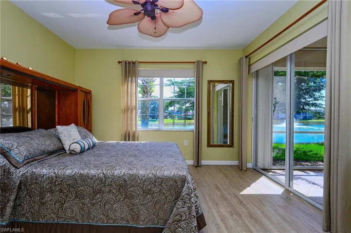 Bedroom with a ceiling fan, light wood-style flooring, access to exterior, and baseboards