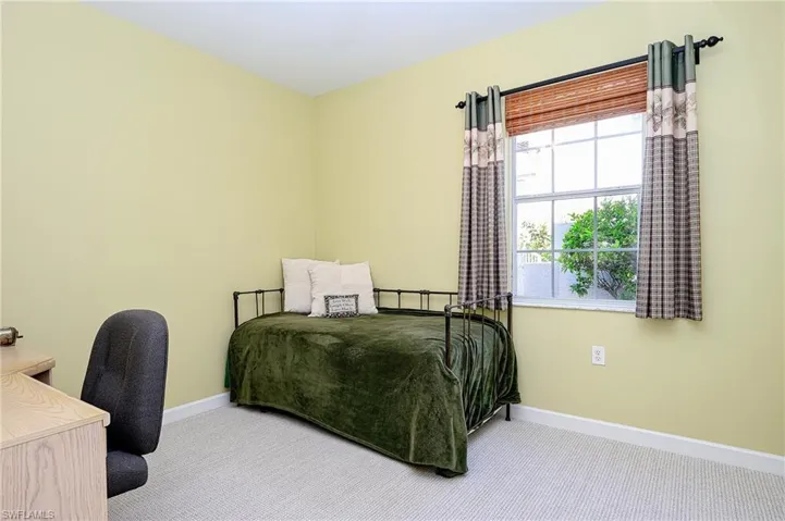 Bedroom with carpet flooring and baseboards