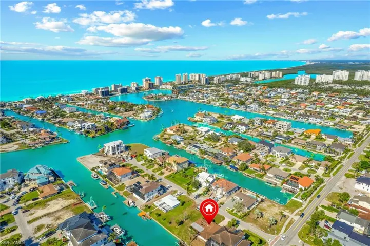Birds eye view of property with a water view
