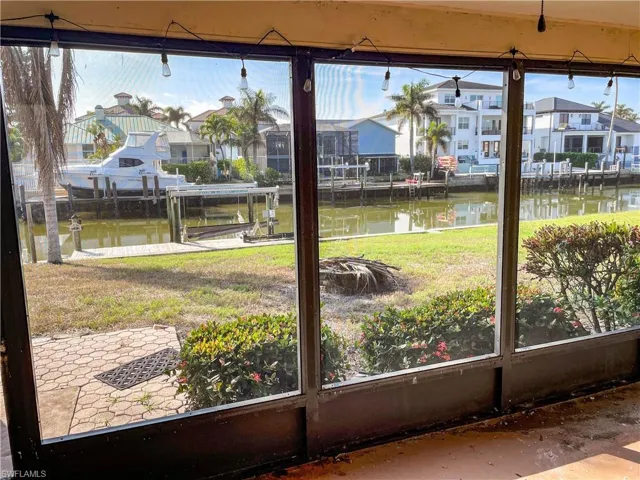 Unfurnished sunroom featuring a water view and a healthy amount of sunlight