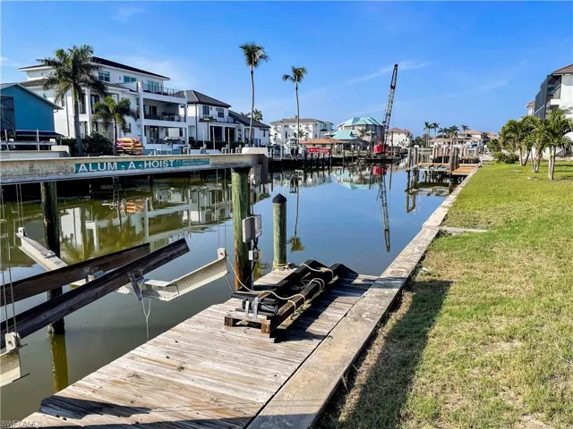 Dock area featuring a water view and a lawn