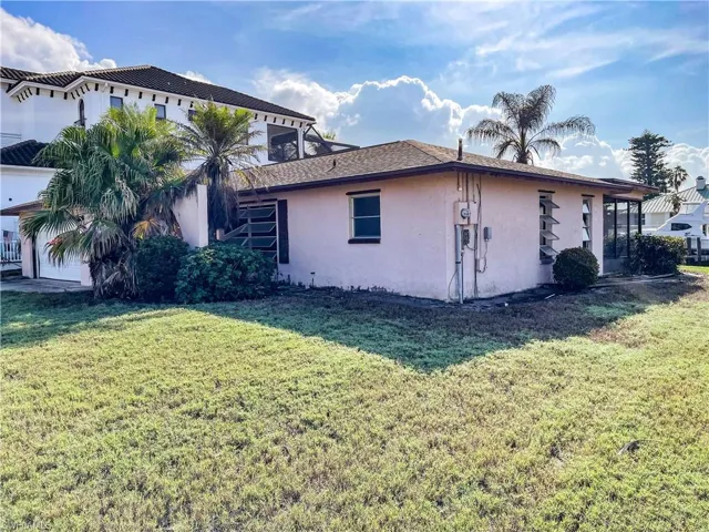 View of property exterior featuring a lawn