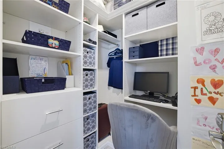 1 of 2 primary closets used as mini office