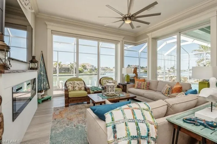 Sunroom featuring a water view and ceiling fan