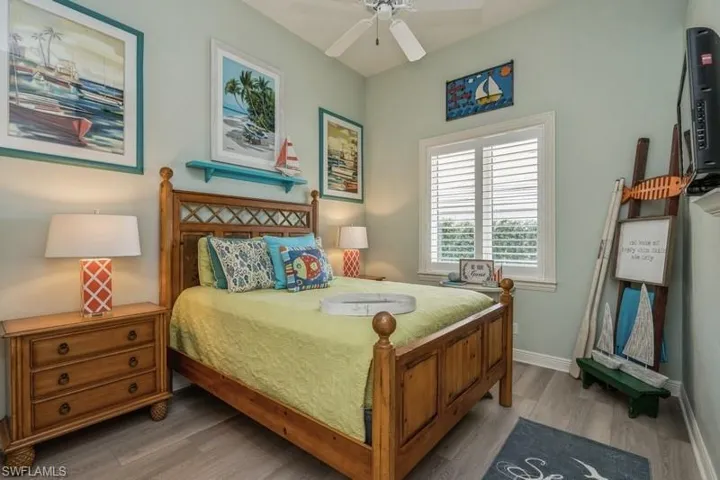 Bedroom featuring wood-type flooring and ceiling fan