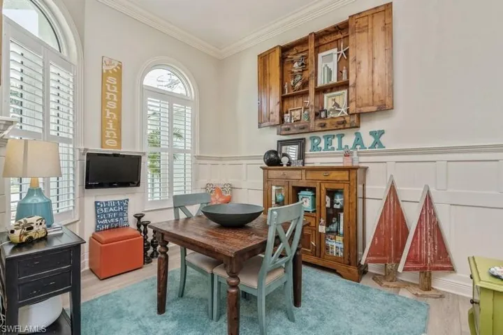 Dining area featuring crown molding and light hardwood / wood-style floors