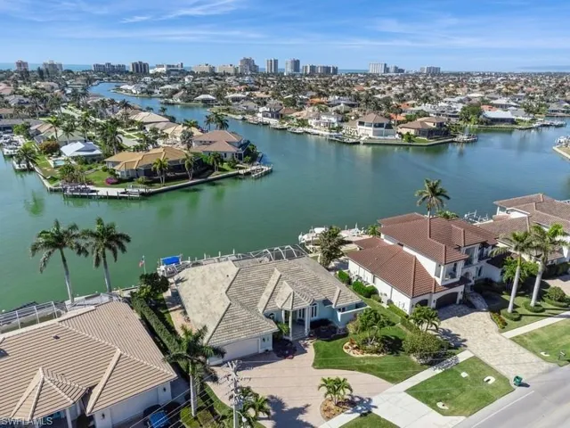 Birds eye view of property with a water view
