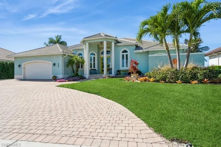 Mediterranean / spanish house featuring a garage and a front yard