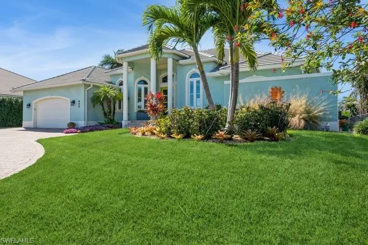 View of front of house featuring a garage and a front yard