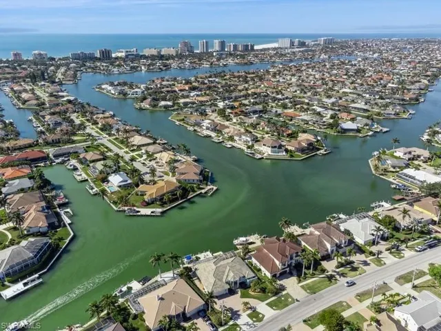 Birds eye view of property with a water view
