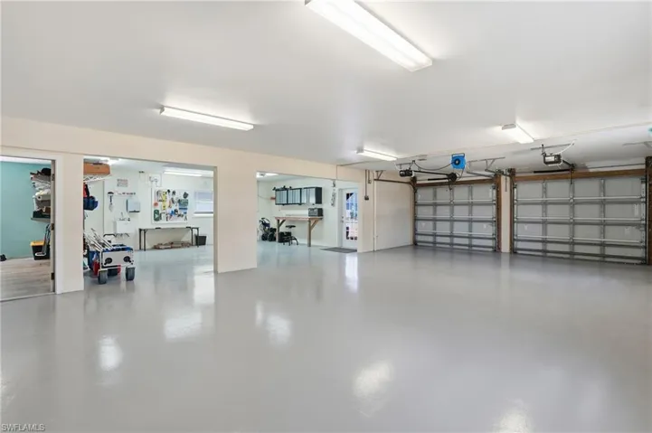 View of Huge Garage with ample storage and workout area - Virtually Edited Image