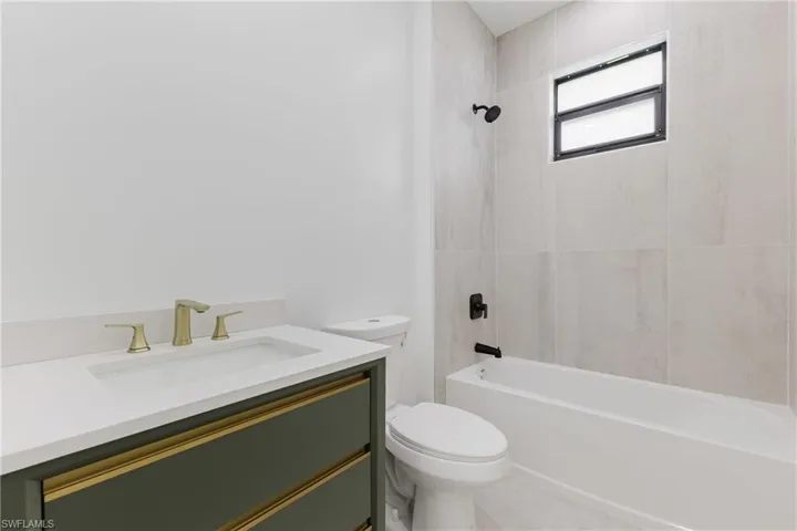 Bathroom with vanity and bathing tub / shower combination