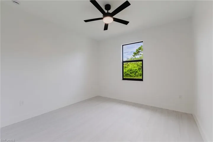 Empty room with baseboards and ceiling fan