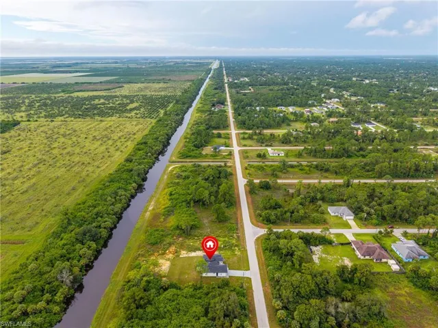 View of rural area featuring a nearby body of water and abundant farmland
