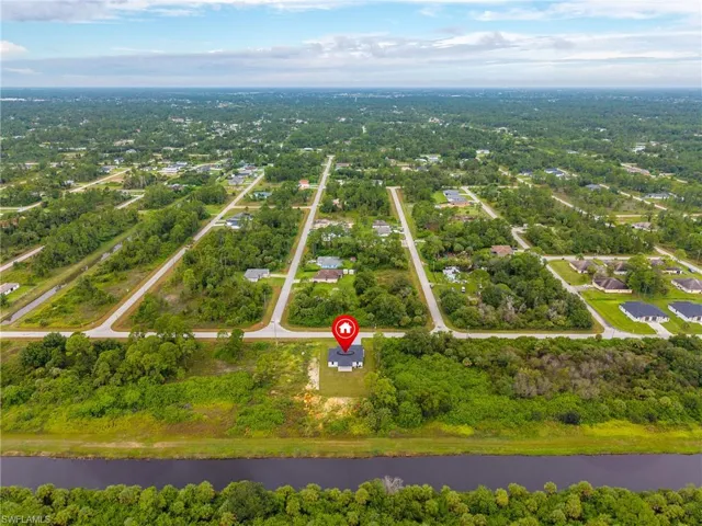 Aerial view of property's location with a large body of water