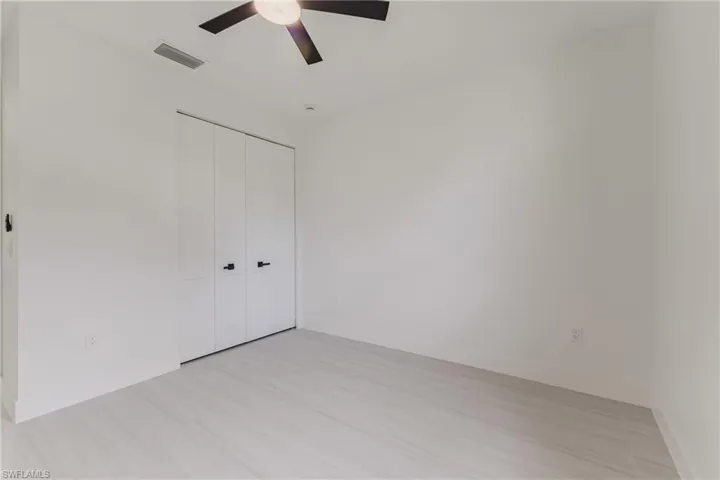 Unfurnished bedroom with a closet and a ceiling fan