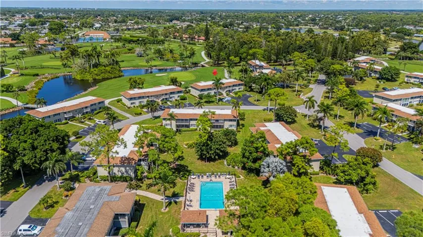 Aerial view of property's location with a nearby body of water, a local golf course, and nearby suburban area