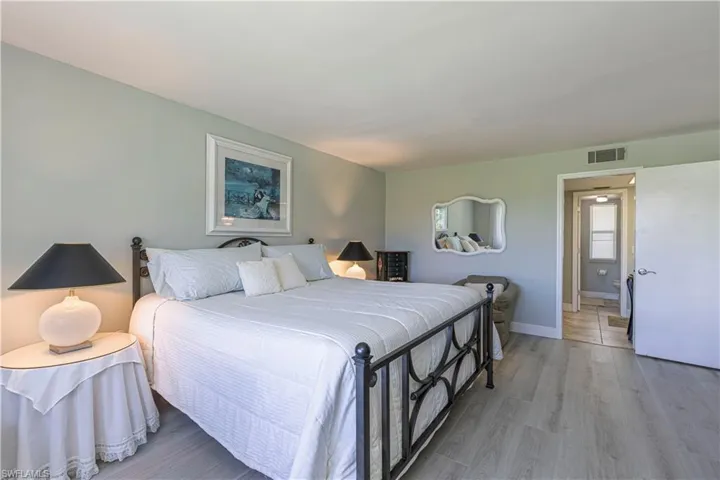 Bedroom featuring wood finished floors and baseboards