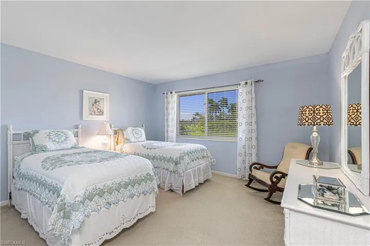 Carpeted bedroom featuring baseboards
