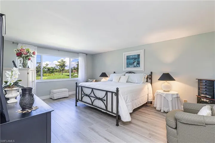 Bedroom featuring wood finished floors and baseboards