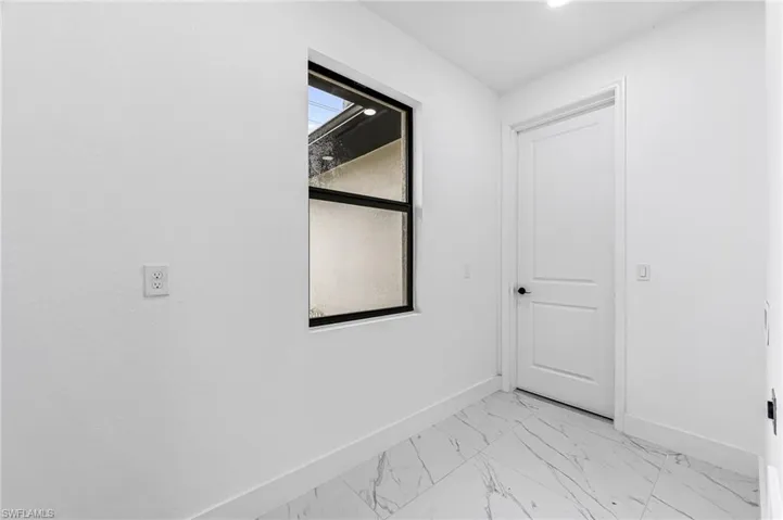 Empty room featuring light tile flooring