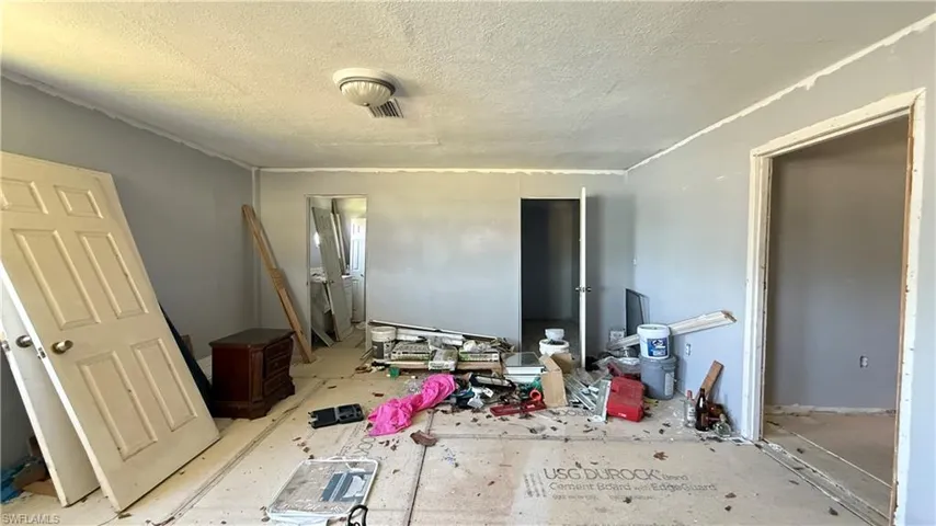 Bedroom with a textured ceiling
