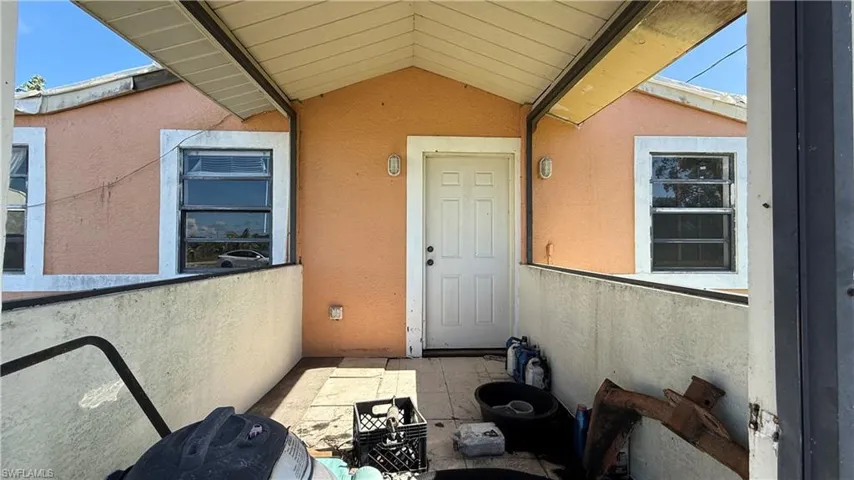 Property entrance featuring stucco siding
