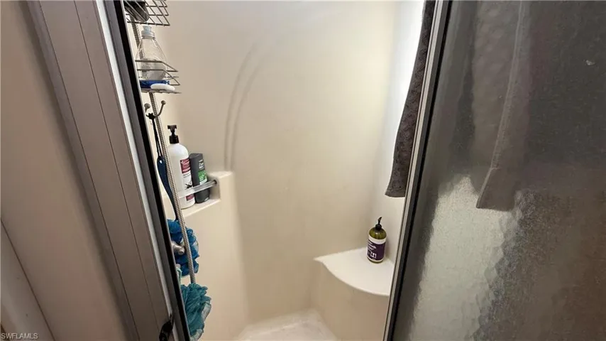 Full bath featuring a shower stall