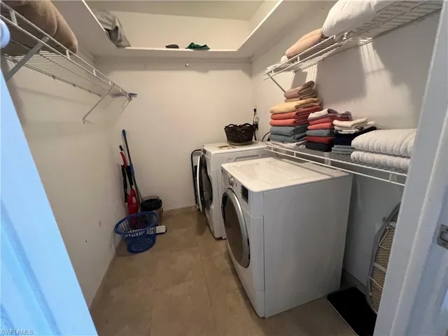 Washroom featuring washing machine and dryer