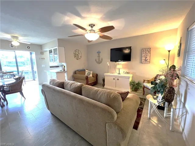 Living room with ceiling fan and a textured ceiling
