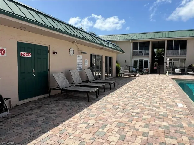 View of patio with french doors and a community pool
