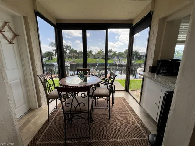 Sunroom / solarium with plenty of natural light and a water view