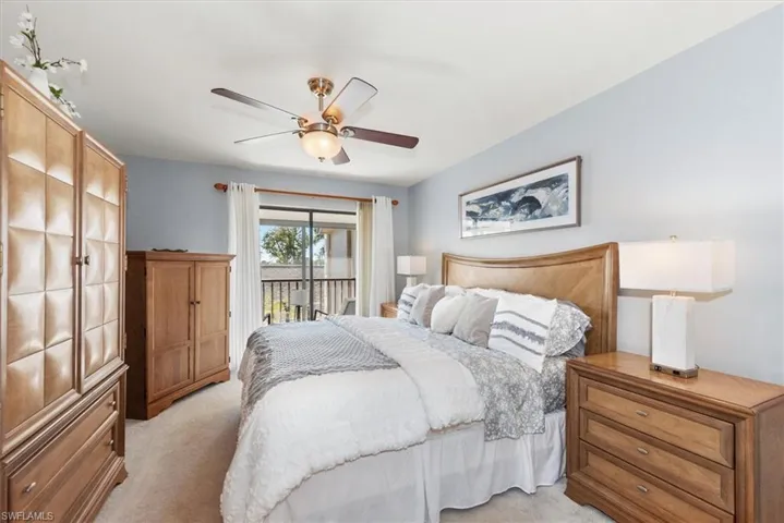 Bedroom with light carpet, access to exterior, and ceiling fan