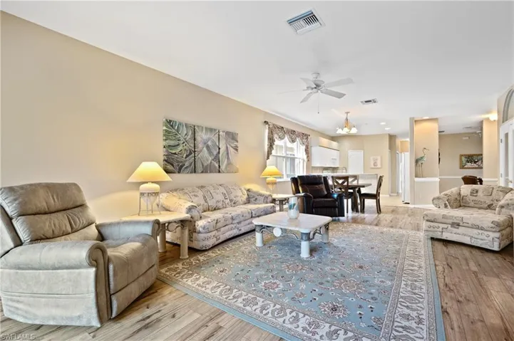Living room with light hardwood / wood-style flooring and ceiling fan