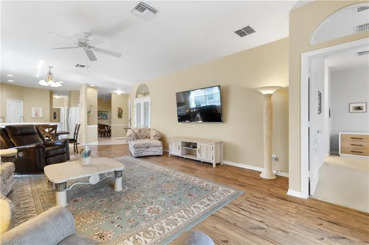 Living room featuring ceiling fan and light hardwood / wood-style flooring