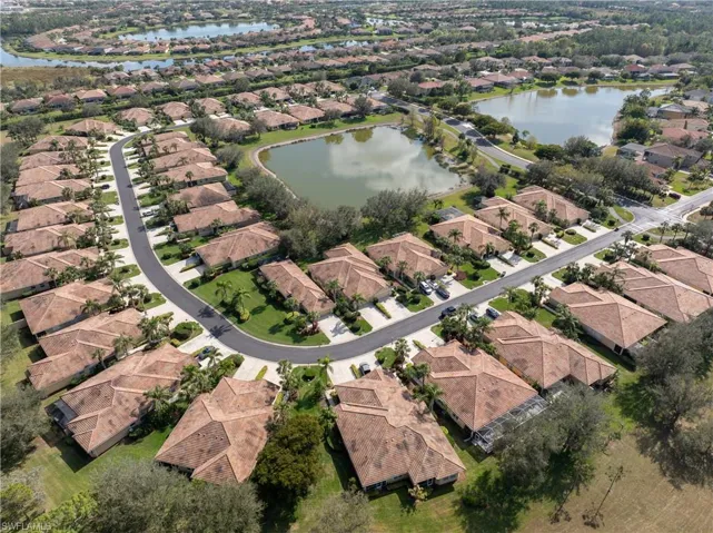 Birds eye view of property with a water view