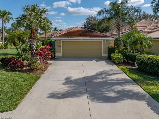 View of front of house featuring a garage and a front lawn