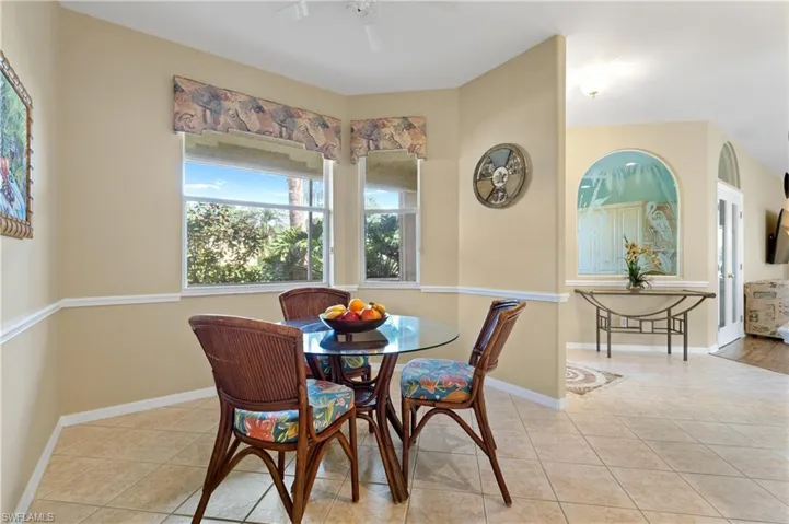 Dining area with light tile patterned floors and ceiling fan