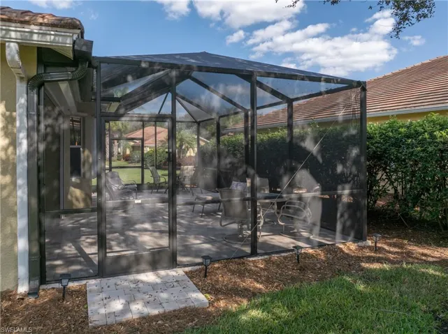 View of patio featuring glass enclosure